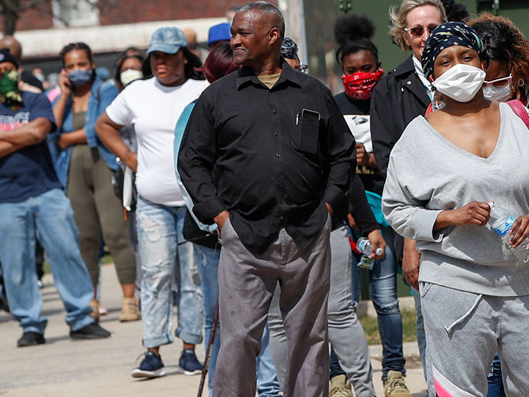 People standing in line with face masks